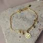Pulsera con tejido paper clic con dije de carita #131