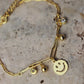 Pulsera con tejido paper clic con dije de carita #131